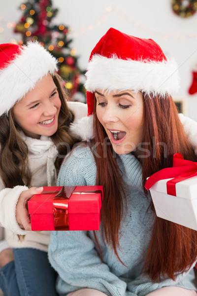 Festive mother and daughter exchanging gifts Stock photo © wavebreak_media