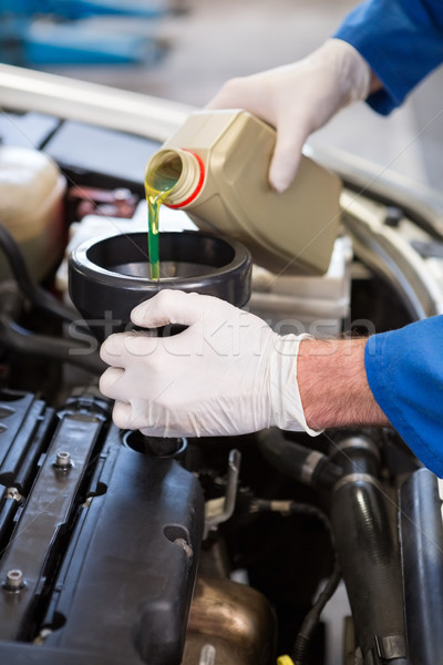Mechanic pouring oil into car Stock photo © wavebreak_media