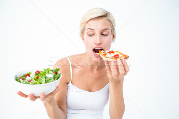 Pretty woman deciding eating pizza rather the salad Stock photo © wavebreak_media