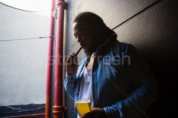 Man smoking while having beer Stock photo © wavebreak_media