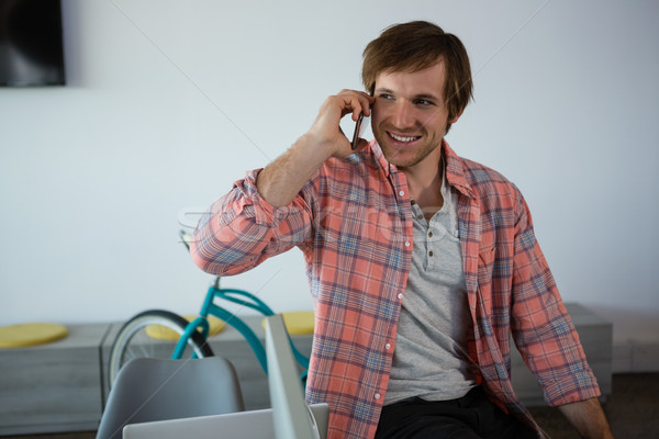 Stock photo: Smiling businessman talking on phone