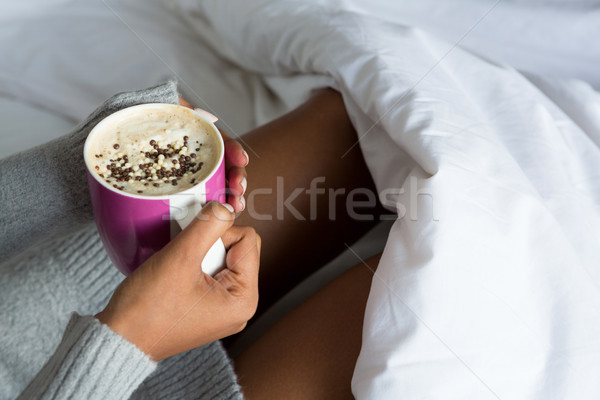 Cropped image of woman having coffee on bed Stock photo © wavebreak_media