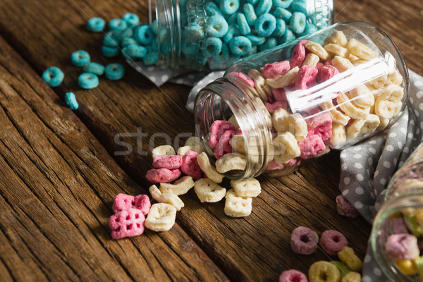 Scattered cereals from jar on wooden table Stock photo © wavebreak_media