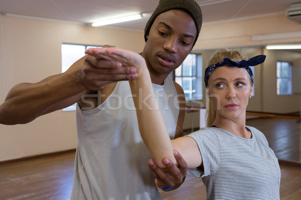Young man assisting female friend in dance Stock photo © wavebreak_media