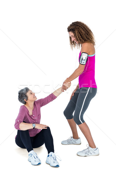 Friend assisting woman in getting up Stock photo © wavebreak_media