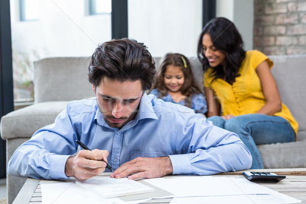 Stock photo: Handsome father paying bills