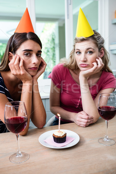 Portrait of sad friends sitting at table during birthday party Stock photo © wavebreak_media