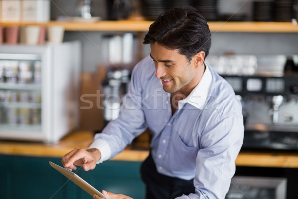 Smiling man using digital tablet  Stock photo © wavebreak_media