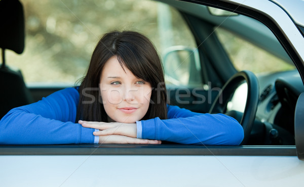 Attractive teen girl smiling at the camera sitting in her car Stock photo © wavebreak_media