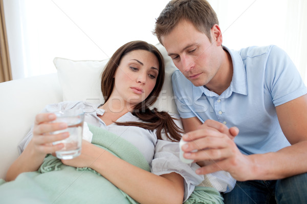 Carring man nursering his sick wife Stock photo © wavebreak_media