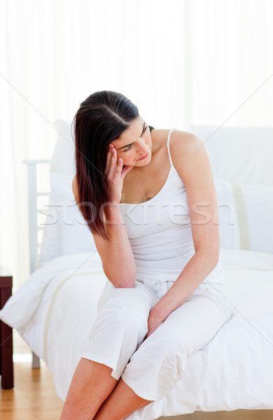 Upset woman sitting on her bed after having a row with her husband Stock photo © wavebreak_media