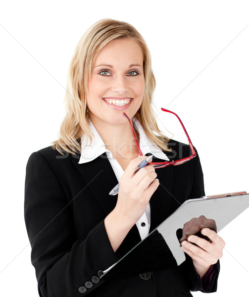 Charismatic businesswoman holding a clipboard against white background Stock photo © wavebreak_media