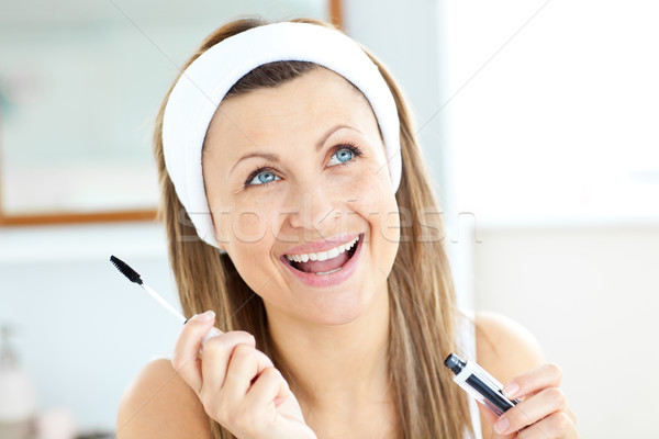 Radiant caucasian woman using mascara in the bathroom at home Stock photo © wavebreak_media