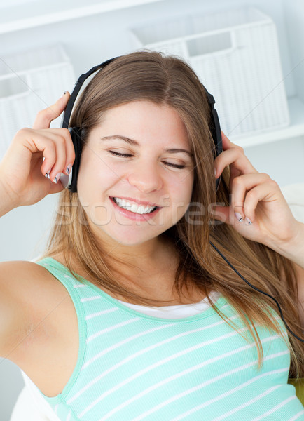 Good-looking girl listening to music at home Stock photo © wavebreak_media