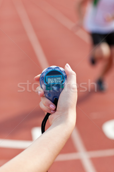 Close-up of a woman holding a chronometer to measure performances of a sprinter in a stadium Stock photo © wavebreak_media