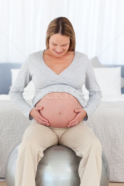 Cute femme enceinte toucher ventre séance fitness [[stock_photo]] © wavebreak_media