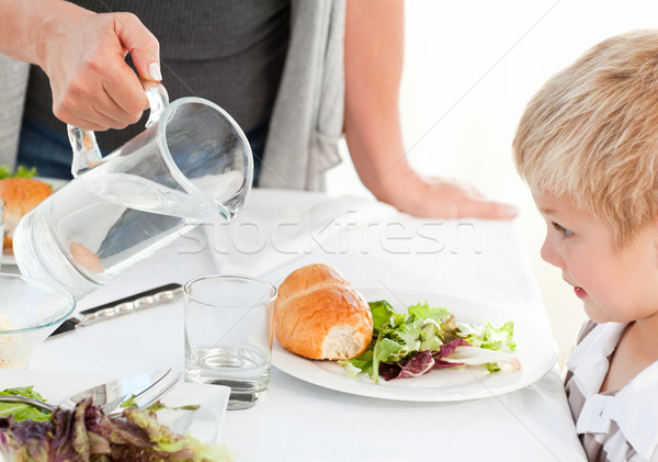 Stock photo: Grandmother serving her grandson at home