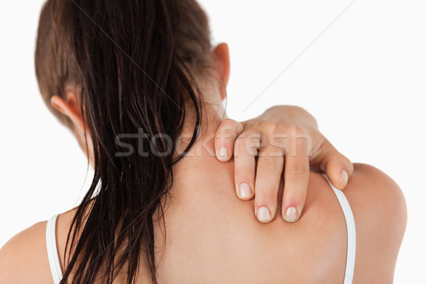 Back view of young woman with neck pain against a white background Stock photo © wavebreak_media