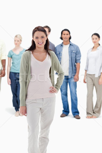 Close-up of people behind a smiling woman with her hand on her hip against white background Stock photo © wavebreak_media