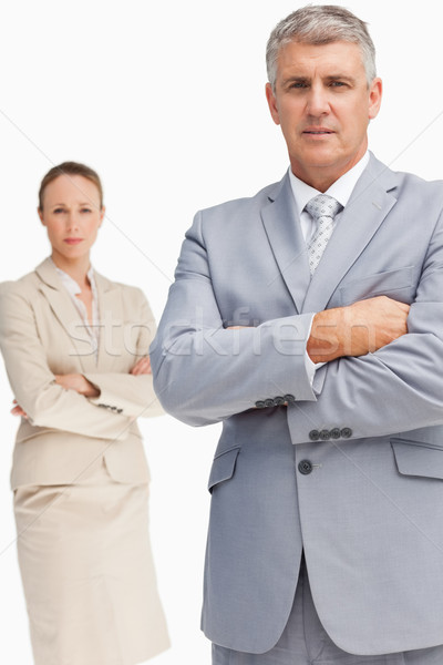 Serious business people standing with folded arms against white background Stock photo © wavebreak_media