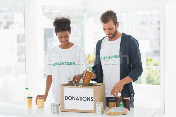 Smiling young couple with donation box Stock photo © wavebreak_media