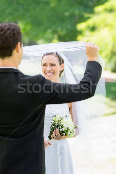 Groom unveiling his bride in park Stock photo © wavebreak_media