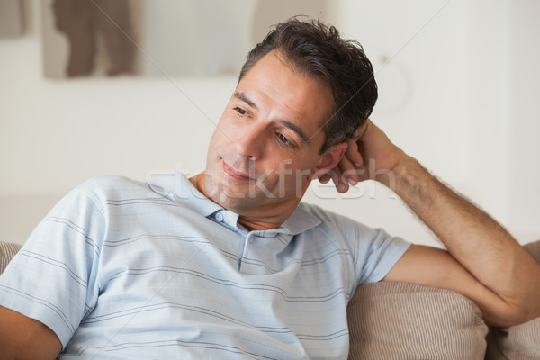 Close-up of a thoughtful man sitting on sofa Stock photo © wavebreak_media