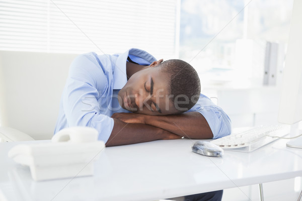 Tired businessman sleeping at his desk Stock photo © wavebreak_media