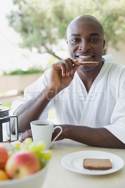 Homem bonito roupão de banho café da manhã fora casa Foto stock © wavebreak_media