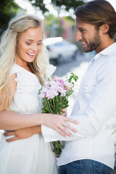 Stock photo: Attractive couple with bunch of flowers