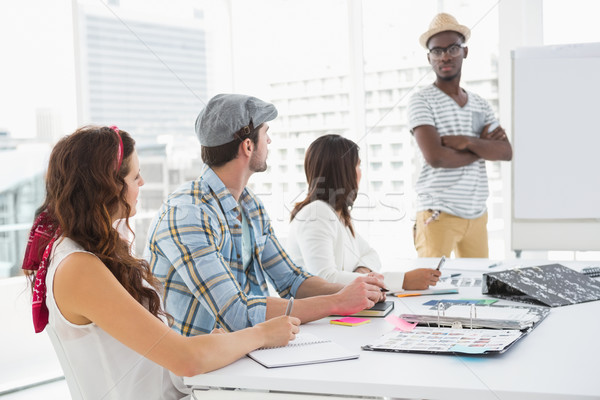 Serious colleagues listening businessman attentively Stock photo © wavebreak_media