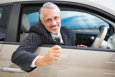Smiling businessman using laptop on the phone Stock photo © wavebreak_media