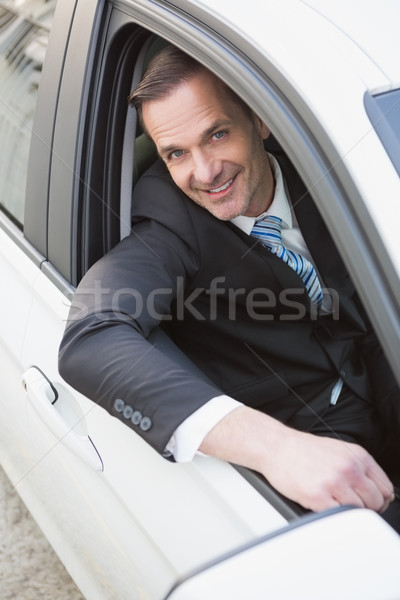 Handsome businessman smiling at camera Stock photo © wavebreak_media