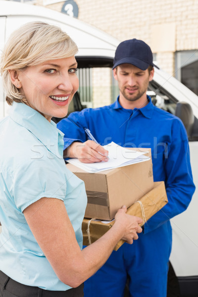  Happy delivery man with customer Stock photo © wavebreak_media