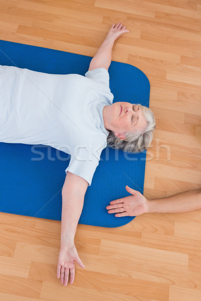 Senior woman lying on exercise mat  Stock photo © wavebreak_media