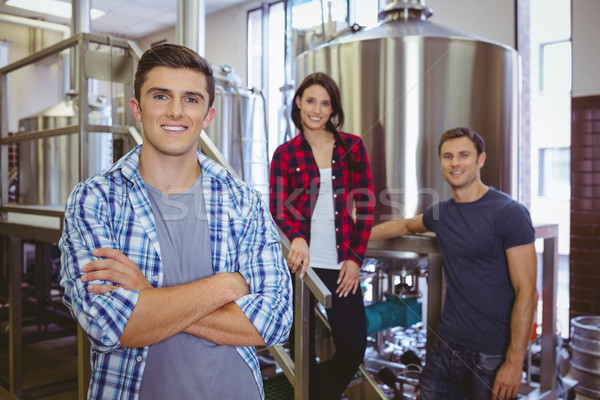 Casual happy stylish team smiling at camera together Stock photo © wavebreak_media