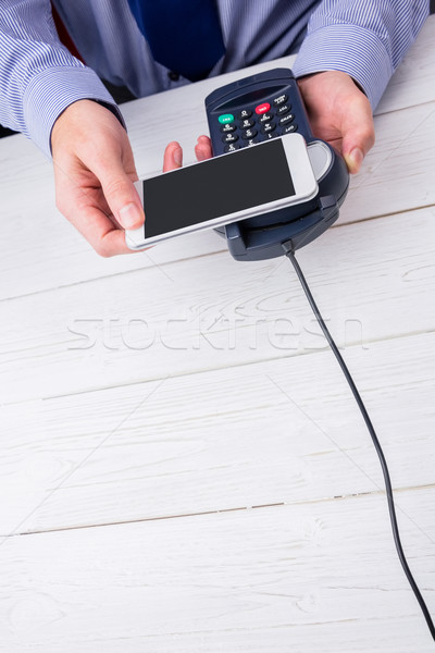 Férfi okostelefon expressz illetmény fa asztal üzlet Stock fotó © wavebreak_media