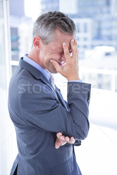 Troubled businessman holding his head Stock photo © wavebreak_media