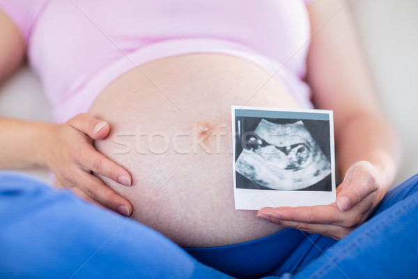 Terhes nő mutat ultrahang megérint has nappali Stock fotó © wavebreak_media