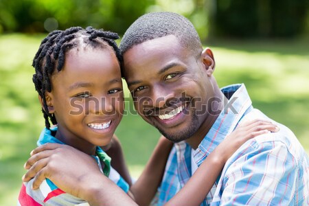Mother and daughter laying in the park against house outline in background Stock photo © wavebreak_media