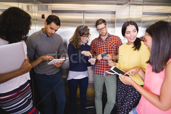 Sonriendo gente de negocios ascensor pie empresario Foto stock © wavebreak_media