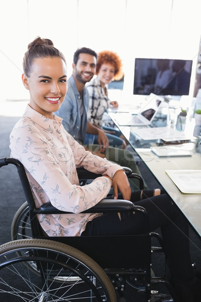 Portrait of smiling businesswoman sitting on wheelchair Stock photo © wavebreak_media