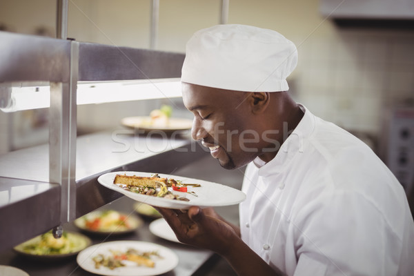 Chef smelling food in commercial kitchen Stock photo © wavebreak_media