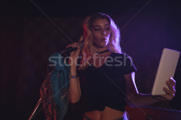 Female singer taking selfie with digital tablet in nightclub Stock photo © wavebreak_media