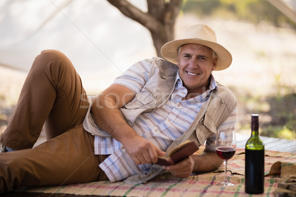 Portrait of happy man reading book in cottage Stock photo © wavebreak_media