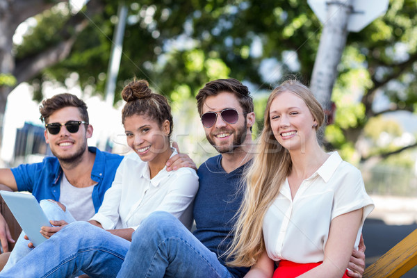 Stock photo: Hip friends holding tablet and smiling at the camera