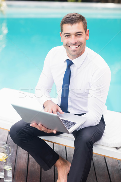 Smarty dressed man using laptop Stock photo © wavebreak_media