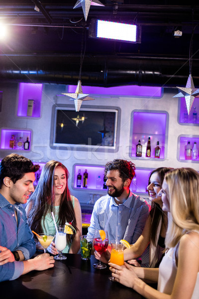 Group of friends interacting with each other at bar counter whil Stock photo © wavebreak_media