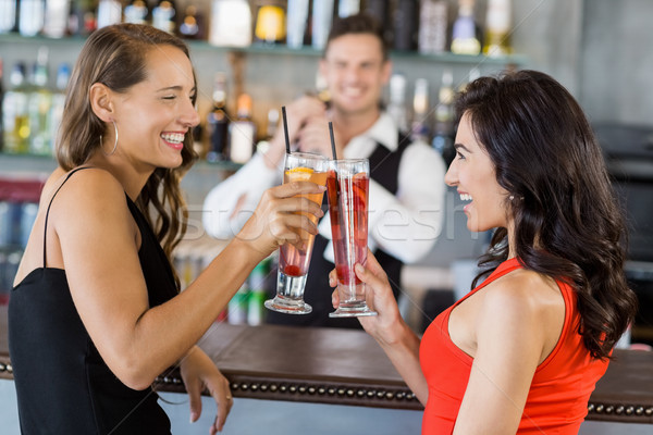 Beautiful women toasting cocktail glasses Stock photo © wavebreak_media