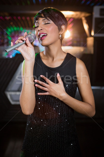 Woman singing in bar Stock photo © wavebreak_media